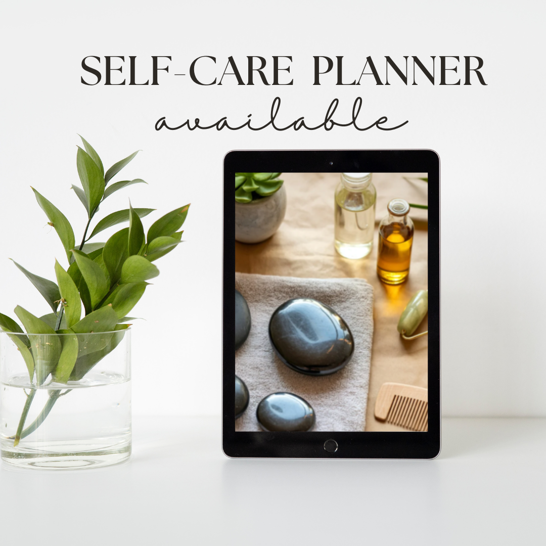 Tablet displaying a self-care routine with stones and oils, next to a plant on a white surface.